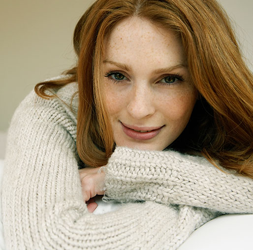 Relaxed red headed woman smiling